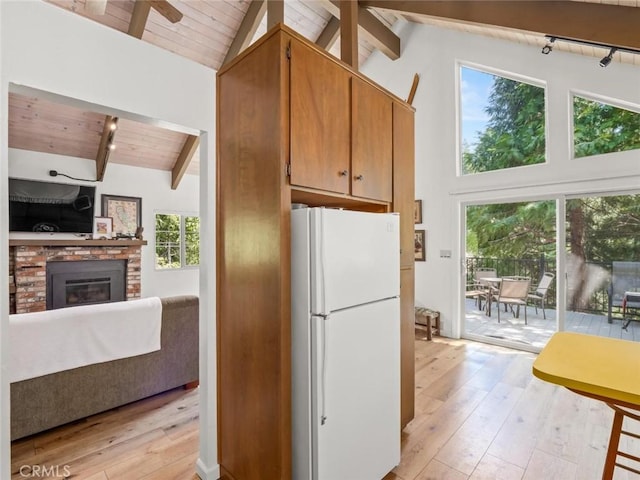 1153 Silvertip Ln, Fish Camp, CA 93623 - kitchen with wood ceiling, a brick fireplace, light hardwood / wood-style floors, and white fridge