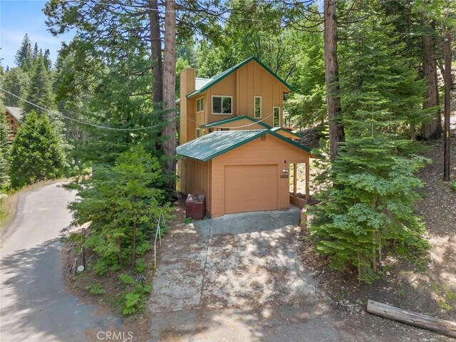 view of property with a garage and an outdoor structure