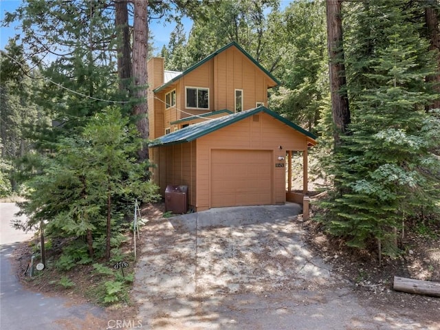 1153 Silvertip Ln, Fish Camp, CA 93623 - view of property featuring a garage and an outdoor structure