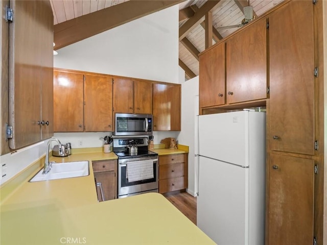 1153 Silvertip Ln, Fish Camp, CA 93623 - kitchen featuring sink, wood ceiling, hardwood / wood-style flooring, appliances with stainless steel finishes, and lofted ceiling with beams