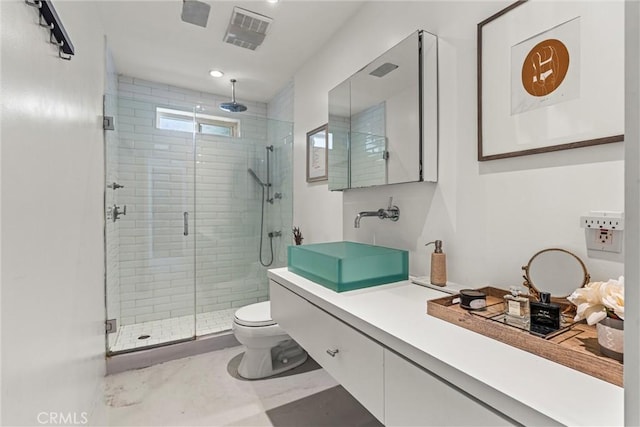 bathroom featuring an enclosed shower, vanity, and toilet