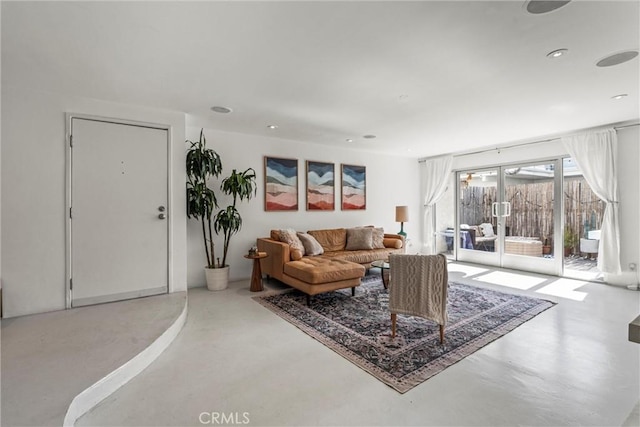 living room featuring concrete floors and french doors