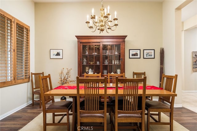 dining area featuring dark hardwood / wood-style floors and a chandelier