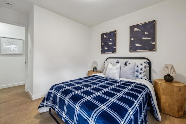 bedroom with hardwood / wood-style floors