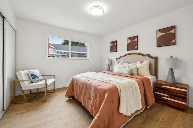 bedroom featuring a closet and light hardwood / wood-style flooring