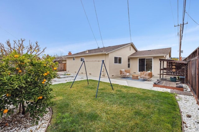 back of house featuring a yard and a patio area