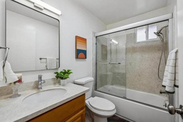 full bathroom with vanity, shower / bath combination with glass door, and toilet