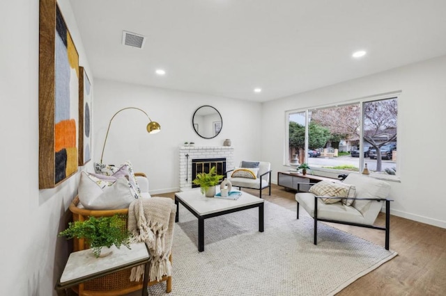 living room with hardwood / wood-style flooring and a fireplace