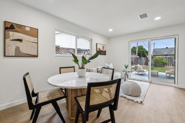 dining space with light hardwood / wood-style floors