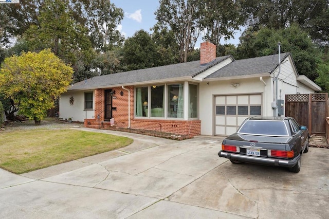 ranch-style home featuring a garage and a front yard