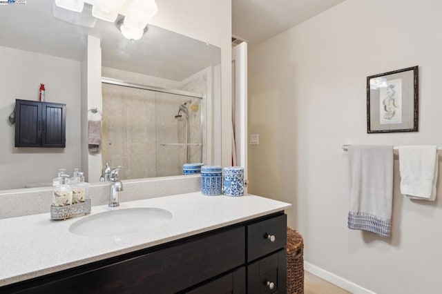 bathroom with vanity and a shower with shower door