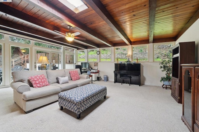 living room with wood ceiling, beam ceiling, a skylight, and light colored carpet