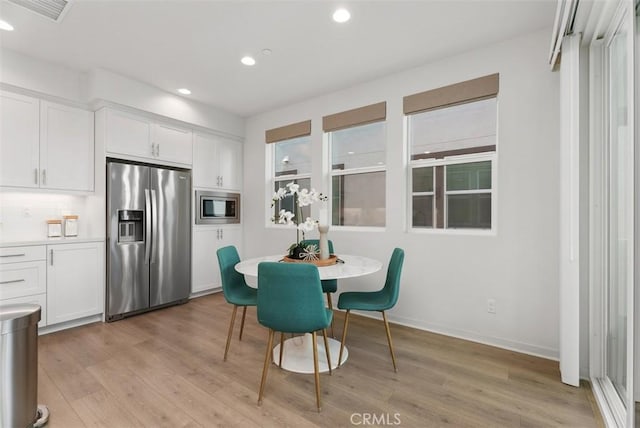 dining area with light hardwood / wood-style flooring