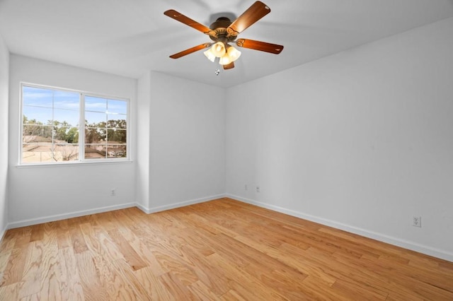 spare room with ceiling fan and light wood-type flooring