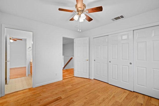 unfurnished bedroom with ceiling fan, a closet, and light hardwood / wood-style flooring