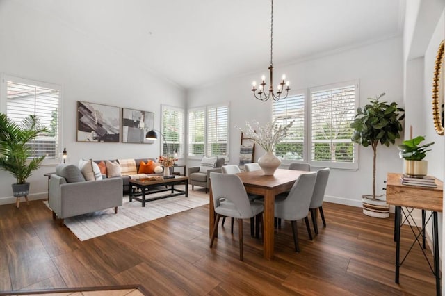 dining room with an inviting chandelier, plenty of natural light, and dark hardwood / wood-style flooring