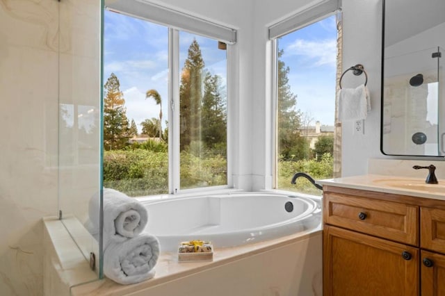 bathroom with vanity and shower with separate bathtub