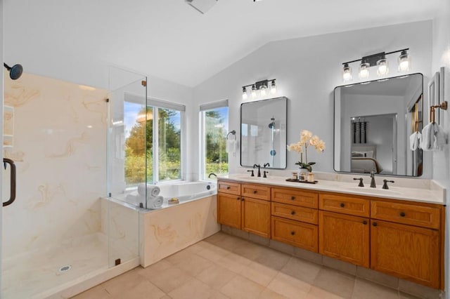 bathroom featuring vanity, tile patterned flooring, vaulted ceiling, and plus walk in shower