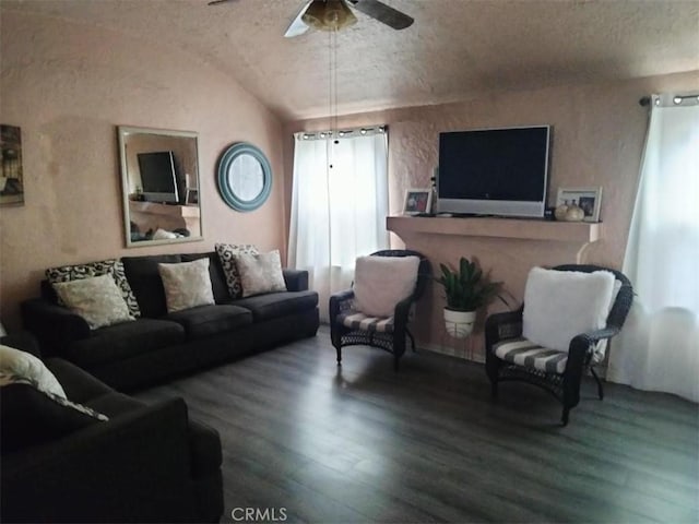 living area featuring lofted ceiling, a ceiling fan, and wood finished floors