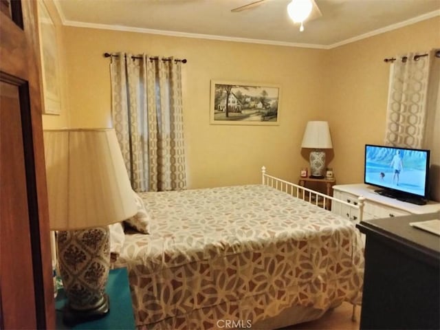 bedroom with ceiling fan and crown molding