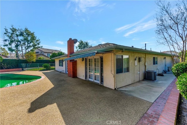 exterior space featuring a fenced in pool, a patio, and central AC