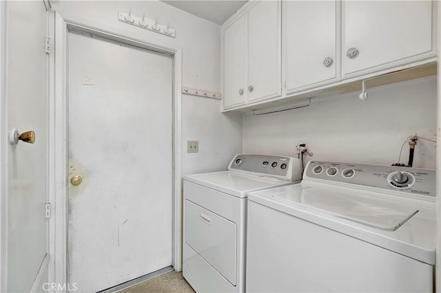 washroom with independent washer and dryer and cabinets