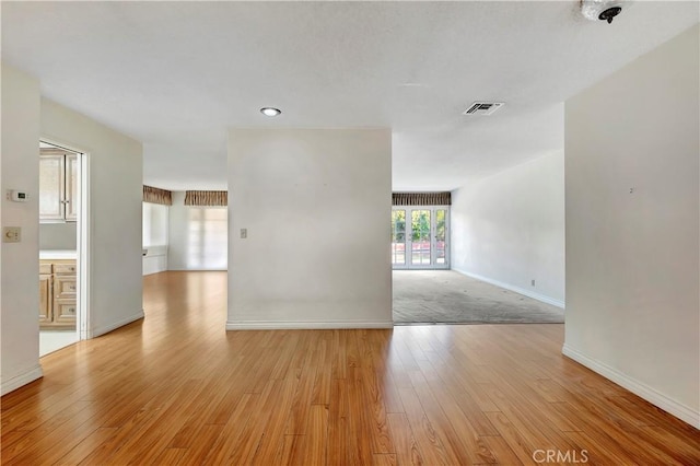 empty room with light hardwood / wood-style floors