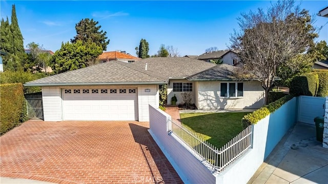 single story home featuring a garage and a front lawn