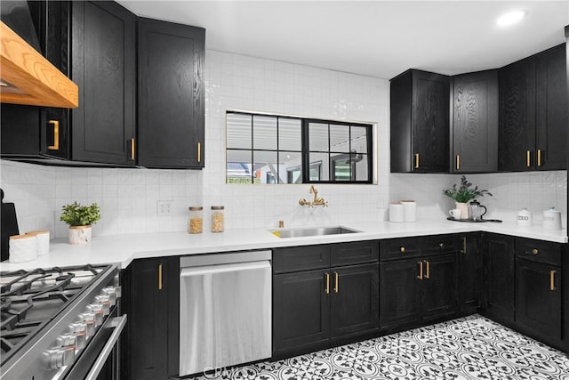 kitchen with sink, light tile patterned floors, backsplash, stainless steel appliances, and custom range hood