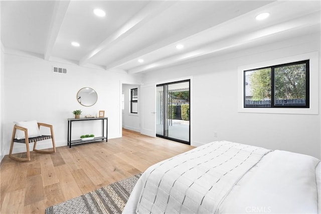 bedroom featuring beamed ceiling, access to outside, and light hardwood / wood-style floors