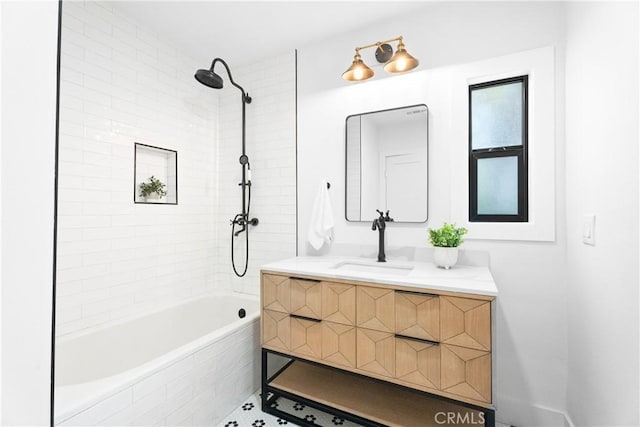 bathroom featuring vanity and tiled shower / bath