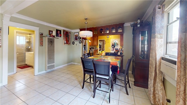 tiled dining space featuring ornamental molding