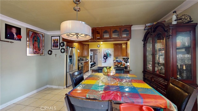 dining area with ornamental molding and light tile patterned floors