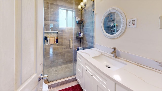 bathroom featuring vanity and a shower with shower door