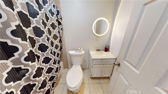 bathroom featuring tile patterned flooring, vanity, and toilet