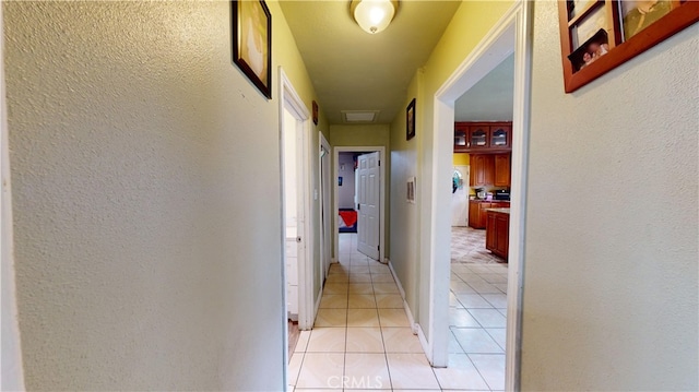 hallway featuring light tile patterned floors