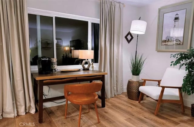 sitting room with hardwood / wood-style flooring