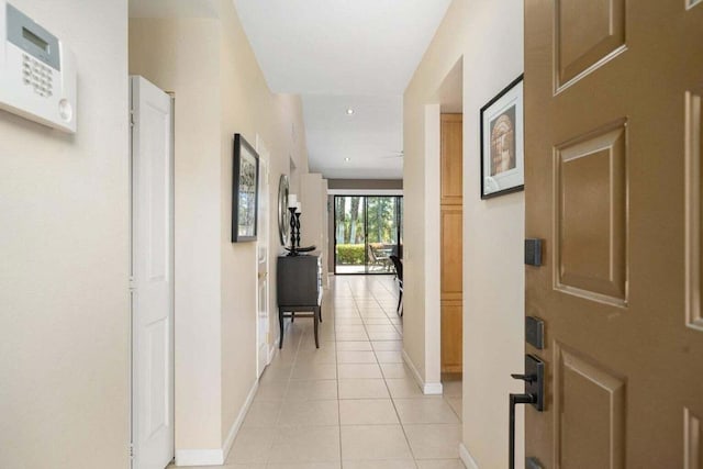 hall with light tile patterned floors