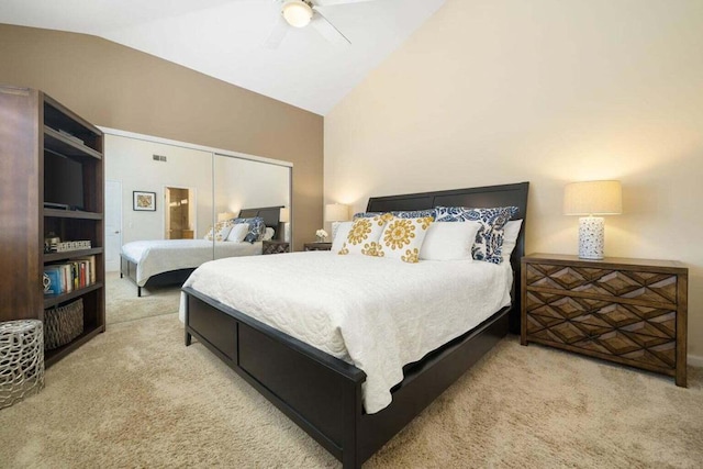 carpeted bedroom featuring lofted ceiling, a closet, and ceiling fan