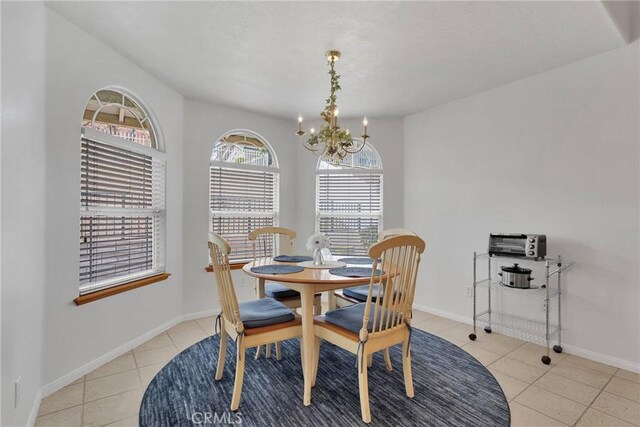 dining room featuring light tile patterned flooring and a notable chandelier