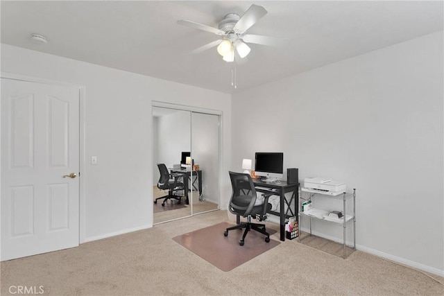 carpeted office space with ceiling fan