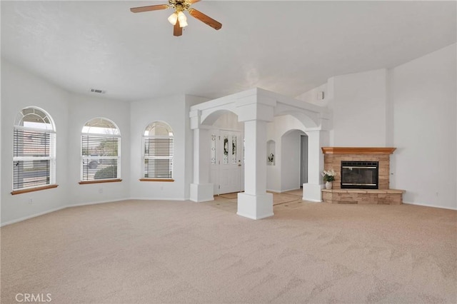 unfurnished living room featuring light colored carpet and ceiling fan