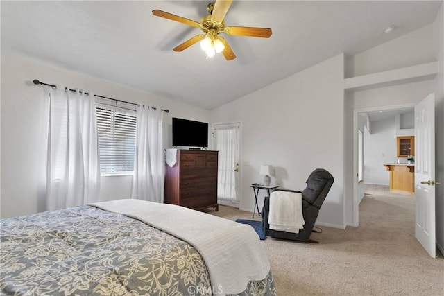 bedroom with vaulted ceiling, light colored carpet, and ceiling fan