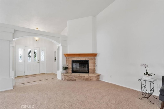 unfurnished living room featuring lofted ceiling, light carpet, and an inviting chandelier