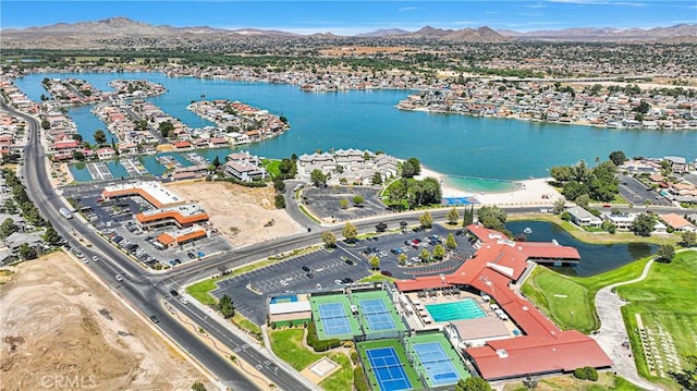 birds eye view of property with a water and mountain view