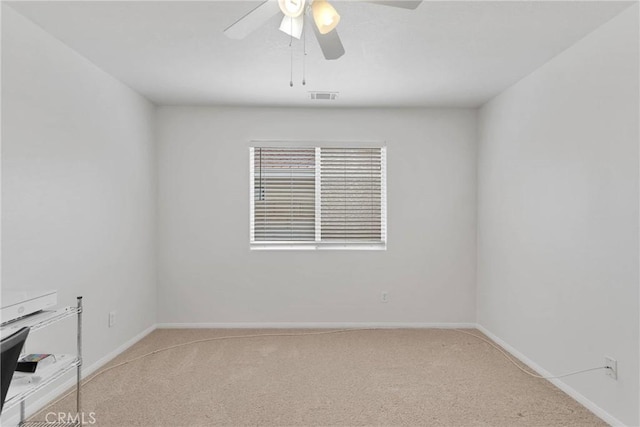 carpeted empty room featuring ceiling fan