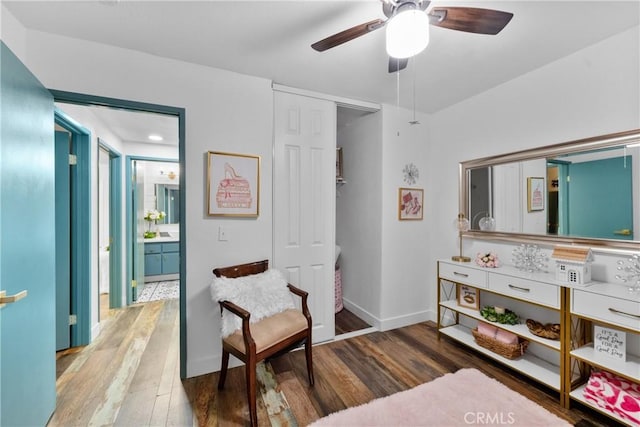 living area with hardwood / wood-style floors and ceiling fan