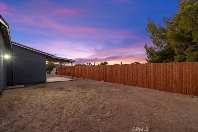 yard at dusk with a patio