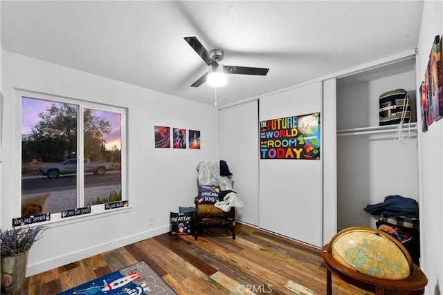 sitting room with hardwood / wood-style flooring and ceiling fan