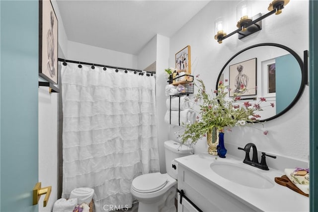 bathroom with vanity, a shower with shower curtain, and toilet